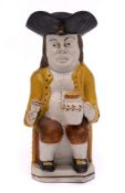 A small Pratt pearlware toby jug: holding a foaming jug in his left hand, a goblet in his right,