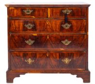 An early 18th Century walnut and crossbanded rectangular chest:, with a quarter veneered top,