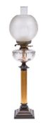 A Victorian brass oil lamp: with clear glass reservoir, on a fluted column and stepped bronze base,