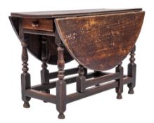 An 18th Century oak oval gateleg dining table:, with a hinged top, the frieze fitted with a drawer,