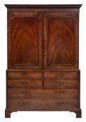 A George III mahogany linen press:, adapted as a gentleman's wardrobe,