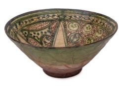 A Persian sgraffito decorated bowl: of conical form the interior incised with animals and circular