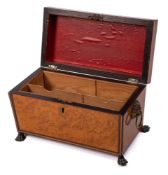 A Regency period burr maple and ebony strung tea caddy: of sarcophagus outline,