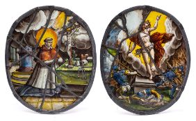 A pair of 17th century South German stained glass oval panels: of a saint kneeling before an altar