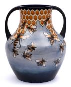 A large Moorcroft pottery vase: of bulbous two handled form tube lined in the Honeycomb pattern