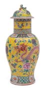 A Chinese famille rose yellow ground baluster vase and cover: with lion pup finial,