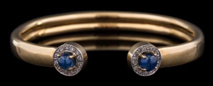 A sapphire and diamond bangle,