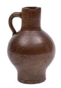 A small late 17th century brown stoneware bottle: with ribbed neck and foot,