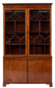 An Edwardian mahogany bookcase:, the upper part with a moulded dentil cornice,