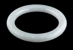 A jadeite bangle,: of plain polished form, 5.7cm inner diameter, 59g.