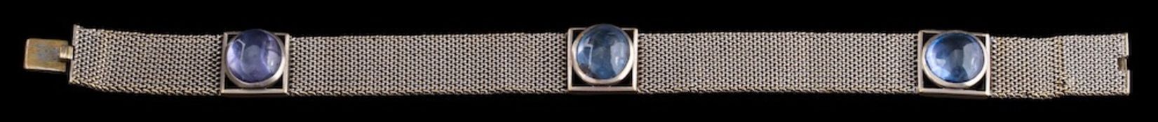 A cabochon sapphire mounted mesh-link bracelet: with three rectangular openwork panels,