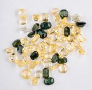 A group of unset yellow sapphires and green sapphires,