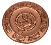 A Newlyn-style copper charger: the centre with embossed fish within a scaly border,