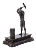 A bronze statue of an Asian native chopping wood: unsigned,