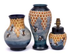 Two Moorcroft pottery vases and a matching lamp: each tube lined in the Honeycomb pattern after a