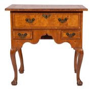 An early 18th Century walnut, oak and cross and feather banded lowboy:,