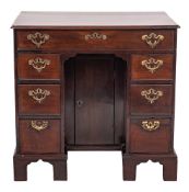 A mid 18th Century mahogany kneehole desk:, of small size, the top with a moulded edge,