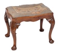 A 19th Century carved mahogany stool:, of serpentine outline in the George II taste,