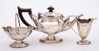 A George V silver three-piece batchelor's pedestal tea set, maker Henry Matthews, Birmingham,