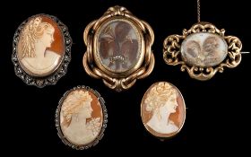 A 19th century hairwork brooch,: the curled hair in a glazed mount, 4.