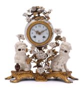 A Louis XV-style ormolu-mounted and blanc-de-chine porcelain mantel clock: with white enamel dial,