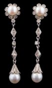 A pair of cultured pearl and diamond mounted pendant drop earrings: each with a cultured pearl