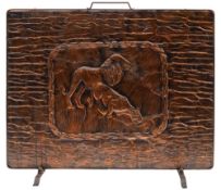 An embossed copper fire screen: of rectangular outline depicting a lion and lioness drinking at a