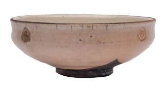 *Inger Rokkjaer [1934-2008] a raku fired stoneware bowl: of footed circular form incised with four