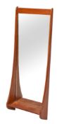 A G-Plan teak wall mirror: the beveled rectangular plate in a swept frame with open shelf beneath,