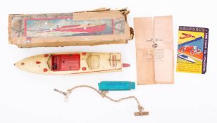 A Hornby clockwork Speed Boat No 3 'Racer III': with white hull and superstructure with red lining,
