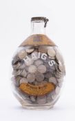 A Dimple Haig bottle full of sixpences including pre 1947: