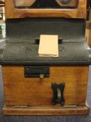 An oak cased 'National Electric' time clocking in clock by the National Time Recorder Co,