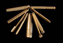 A set of ten 19th century bone teethers : including a hammer, pliers, a saw, a cricket bat,