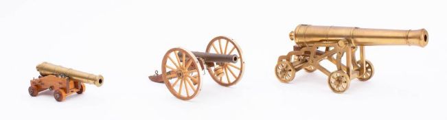 A 9 1/2 inch brass scale model cannon barrel on brass skeletal garrison carriage: together with a 5
