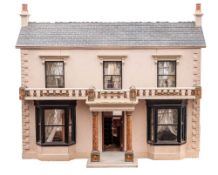 A late 19th/early 20th century double fronted dolls house: double chimney over black simulated