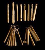 A collection of 19th century bone teethers: including a hammer , a cricket bat and others.