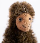 An early 20th century blonde plush Teddy bear: with glass eyes, stitched nose , mouth and claws,