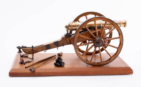 A scale model of a 25 pdr field gun: the brass barrel with crown and GR cipher on an iron bound