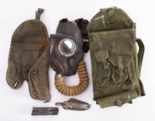 A WWII respirator: together with a canvas pistol holster, tool kit and gun cleaning accessories,