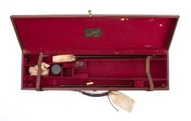 A brown leather gun case by Cogswell & Harrison,