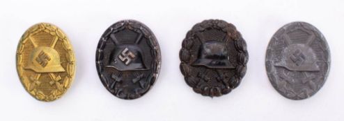 Four Third Reich period and earlier wounds badges: includes black, silver and gold awards,