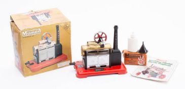 A boxed Mamod Steam Engine SP2: black and brass on a red base, with instructions and accessories.