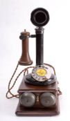 An early 20th century GPO 150 pattern candlestick telephone: with brown Bakelite trumpet,