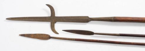 An antique pole arm: the cruciform blade with inverted crosspiece on a pine shaft, 210cm long,