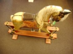 A 20th century rocking horse: inset glass eyes with open mouth and teeth, applied mane and tail,