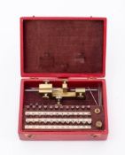 An early 20th century cased Ingold Fraise watchmaking tool: with lacquered brass stand and a set of