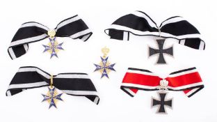 A collection of five replica German awards: includes Pour Le Merite, Pour Le Merite with Crown,