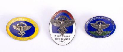 Three Second World War German NSFK enamel badges: dated 1938,