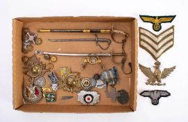 A collection of various military buttons and badges: including two sea mine badges,