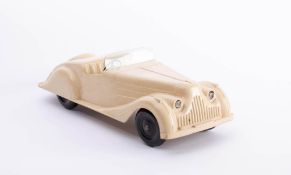 Codeg (UK) A large scale white Bakelite clockwork open tourer car: single piece moulded with